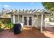 Brick patio with pergola, grill, and double doors at 2016 Seminole Trl, Lakeland, FL 33803