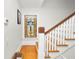 Staircase with hardwood floors, white railings, and a stained glass window at 2016 Seminole Trl, Lakeland, FL 33803