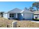 Newly built home features a light blue exterior, attached garage, and a well-maintained lawn at 2021 Alderman Rd, Auburndale, FL 33823