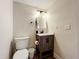 Small bathroom with toilet and a rustic vanity at 2025 Sylvester Rd # N304, Lakeland, FL 33803