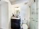 Bathroom featuring a modern vanity and a tiled walk-in shower with sliding glass doors at 2025 Sylvester Rd # N304, Lakeland, FL 33803