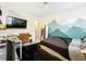 Bedroom with a bed, desk, and mountain mural at 2025 Sylvester Rd # N304, Lakeland, FL 33803