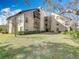 Exterior view of condo building showing landscaping and lawn at 2025 Sylvester Rd # N304, Lakeland, FL 33803