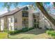 Exterior view of condo building showcasing landscaping at 2025 Sylvester Rd # N304, Lakeland, FL 33803