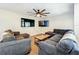 Spacious living room with two TVs, a ceiling fan and comfortable seating at 2025 Sylvester Rd # N304, Lakeland, FL 33803