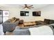 Cozy living room with two TVs, a ceiling fan and comfortable seating at 2025 Sylvester Rd # N304, Lakeland, FL 33803