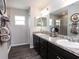 Double vanity bathroom with walk-in shower and dark cabinets at 2210 Oldham Ct, Haines City, FL 33844