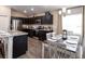 Spacious kitchen with an island, stainless steel appliances, and dark cabinets at 2210 Oldham Ct, Haines City, FL 33844