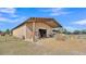 Tan metal barn with covered shelter and hay at 2455 Gerber Dairy Rd, Winter Haven, FL 33880