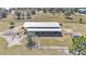 Aerial view of barn with covered stalls and pens at 2455 Gerber Dairy Rd, Winter Haven, FL 33880