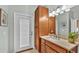 Bathroom with wood vanity, granite countertop and exterior access at 2455 Gerber Dairy Rd, Winter Haven, FL 33880