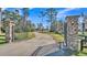 Gated entrance to the property, featuring a long driveway and lush landscaping at 2455 Gerber Dairy Rd, Winter Haven, FL 33880