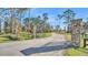 Stone pillars and wrought-iron gate open to a long private drive at 2455 Gerber Dairy Rd, Winter Haven, FL 33880