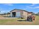 Tan metal workshop with golf cart and tractor at 2455 Gerber Dairy Rd, Winter Haven, FL 33880