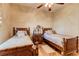 Bedroom with two twin beds and hardwood floors at 3116 Hawks Ridge Dr, Lakeland, FL 33810