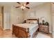 Bedroom with wooden bed frame, nightstand, and ceiling fan at 3116 Hawks Ridge Dr, Lakeland, FL 33810