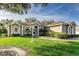 House exterior features a light brown color, manicured lawn, and walkway at 3116 Hawks Ridge Dr, Lakeland, FL 33810