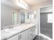 Double vanity bathroom with marble countertop and gray flooring at 3142 Laurel Oak Ln, Winter Haven, FL 33884