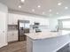 Modern kitchen with island, stainless steel appliances, and marble countertops at 3142 Laurel Oak Ln, Winter Haven, FL 33884