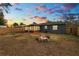 Backyard with fire pit, screened porch and sunset view at 345 Piedmont Ct, Bartow, FL 33830