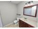 Bathroom with a toilet, vanity, and a framed mirror at 345 Piedmont Ct, Bartow, FL 33830