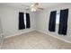 Simple bedroom with two windows, ceiling fan, and tile floor at 345 Piedmont Ct, Bartow, FL 33830