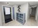 Bright entryway with tile flooring, storage cabinet, and shelving at 345 Piedmont Ct, Bartow, FL 33830