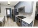 Modern kitchen with gray cabinets, stainless steel appliances, and granite countertops at 345 Piedmont Ct, Bartow, FL 33830