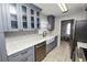 Modern kitchen with gray cabinets, farmhouse sink, and stainless steel appliances at 345 Piedmont Ct, Bartow, FL 33830