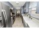 Updated kitchen featuring gray cabinets, stainless steel appliances, and a farmhouse sink at 345 Piedmont Ct, Bartow, FL 33830