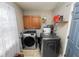 Bright laundry room, washer, dryer, cabinets, and window at 345 Piedmont Ct, Bartow, FL 33830