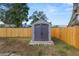 Gray storage shed in backyard with wooden fence at 345 Piedmont Ct, Bartow, FL 33830