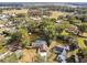 Aerial view of a house with a pool, showcasing the property and surrounding neighborhood at 3457 Christina Groves Ln, Lakeland, FL 33813