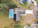 Aerial view of home showing pool, solar panels, and large backyard at 3457 Christina Groves Ln, Lakeland, FL 33813