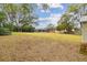 Large backyard with grassy area and distant view of home at 3457 Christina Groves Ln, Lakeland, FL 33813