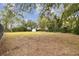 Large backyard with grassy area and distant view of shed at 3457 Christina Groves Ln, Lakeland, FL 33813