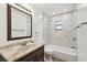 Clean bathroom with marble-tiled shower/tub combo and vanity at 3457 Christina Groves Ln, Lakeland, FL 33813