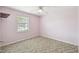 Bright bedroom featuring a window with blinds and neutral walls at 3457 Christina Groves Ln, Lakeland, FL 33813