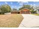 Two-car garage and a long driveway leading to the house at 3457 Christina Groves Ln, Lakeland, FL 33813