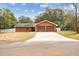 Home exterior featuring a two-car garage and a long driveway at 3457 Christina Groves Ln, Lakeland, FL 33813