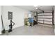 Garage with storage shelves and overhead door at 3457 Christina Groves Ln, Lakeland, FL 33813