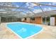 Sparkling pool, screened enclosure, and grassy backyard at 3457 Christina Groves Ln, Lakeland, FL 33813