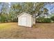 Small beige shed in the backyard with grassy area at 3457 Christina Groves Ln, Lakeland, FL 33813