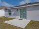 The backyard features a small concrete patio with a sliding glass door entry and an adjacent lawn area at 34575 Shellback St, Leesburg, FL 34788