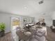 Living room and dining area with wood floors and large sliding glass doors that bring in natural light at 34575 Shellback St, Leesburg, FL 34788