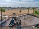 Community playground area features play structures, swings, and a mulch ground cover in a fenced area at 34575 Shellback St, Leesburg, FL 34788