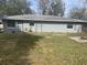 Backyard view with a shed, fence and grassy area at 3638 W Wheeler Rd, Lakeland, FL 33810