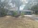 House exterior with a tree in front and a lawn at 3638 W Wheeler Rd, Lakeland, FL 33810