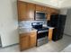 Kitchen features stainless steel appliances and wood cabinets at 3638 W Wheeler Rd, Lakeland, FL 33810