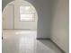 Bright living room with tile flooring and arched entryway at 3638 W Wheeler Rd, Lakeland, FL 33810